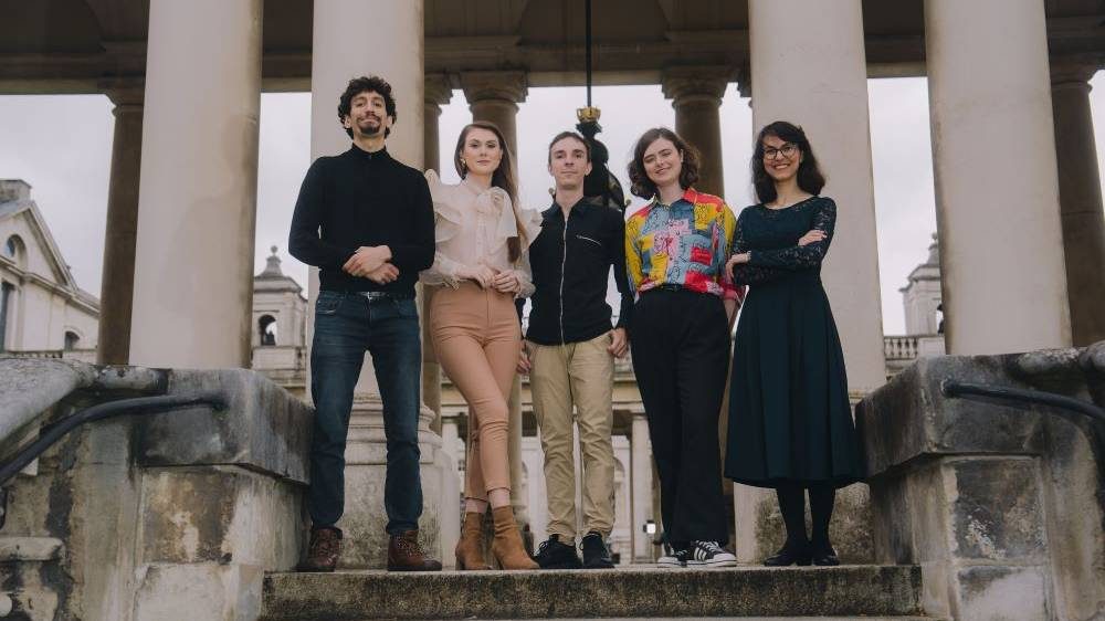 The 2025 Mercers' Award winners stand at the top of some steps.