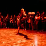 Trinity Laban CoLab 2024 Finale - Credit Sienna Lorraine Gray A man is breakdancing in the midst of a circle of people.